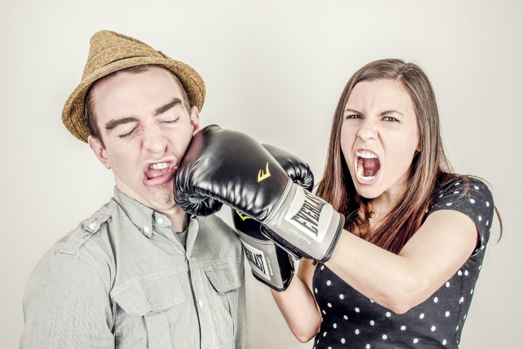 woman angry and punching man 