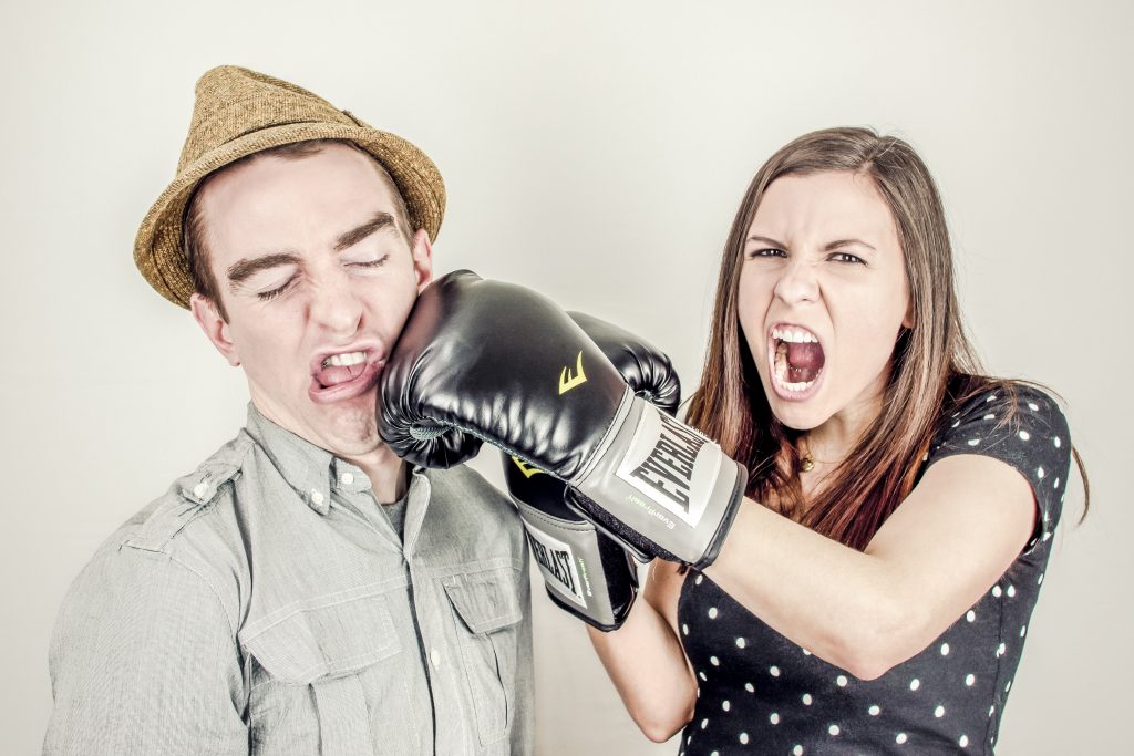 woman angry and punching man